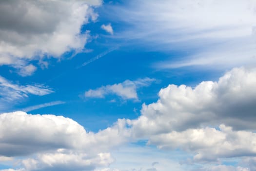 white whispy clouds in a vibrant blue sky
