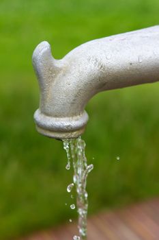 running tap outdoors showing water flowing