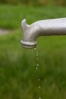 running tap outdoors showing water flowing