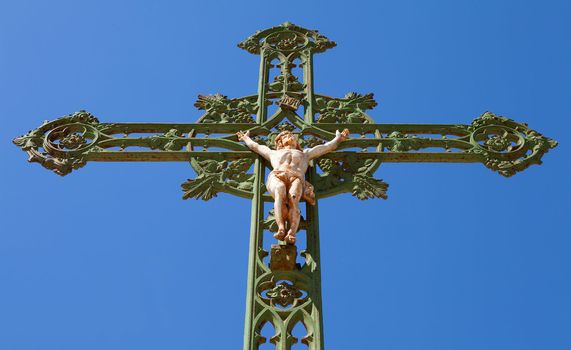Statue of jesus on cross against blue sky