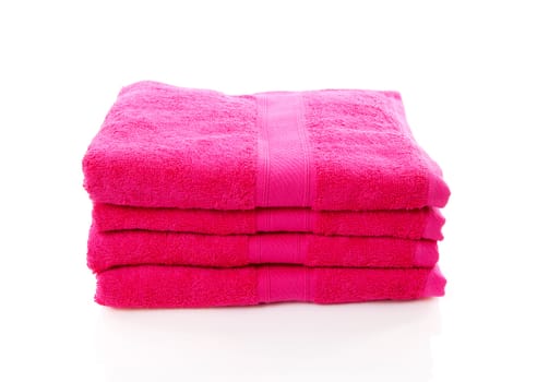 pile of pink towels over white background