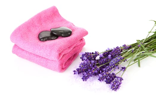 Spa accessory with pink towels, black stapping stones and lavender flowers