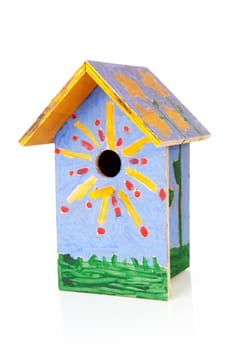 Colorful birdhouse painted by children over white background