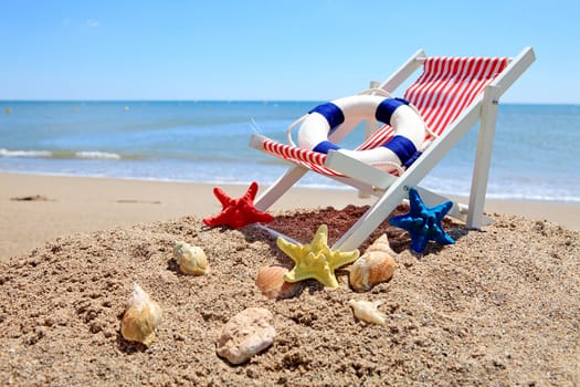 Beach chair near the ocean with shells on sunny day