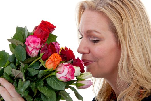 woman is smelling bouquet of colorful roses over white background