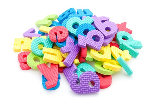Pile of colorful foam letters over white background