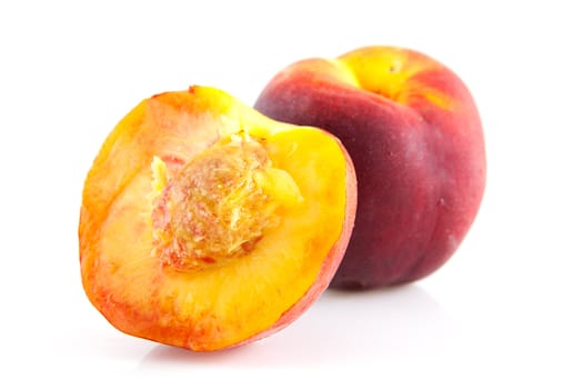 whole and half peach on white background
