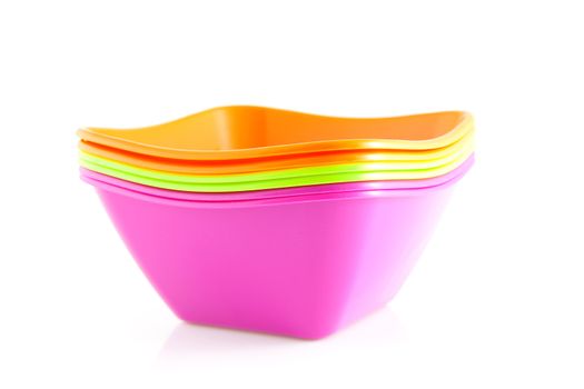 Pile of colorful bowls over white background