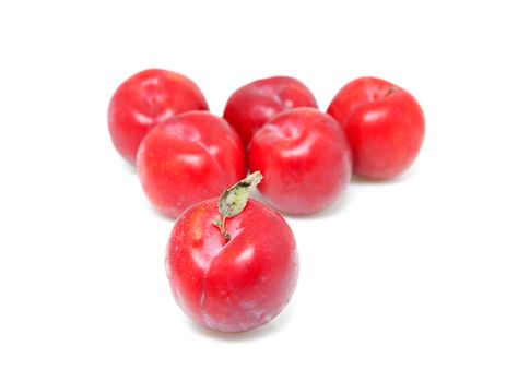 Group of fresh plums over white background