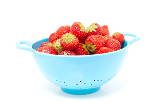 colander with fresh sreawberries over white background
