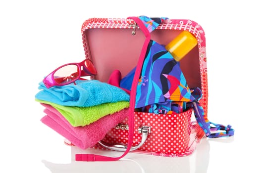Going on vacation; accessories and suitcase over white background