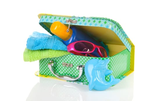 Going to the beach; accessories and suitcase over white background