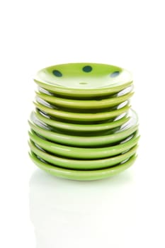 Pile of green plates over white background