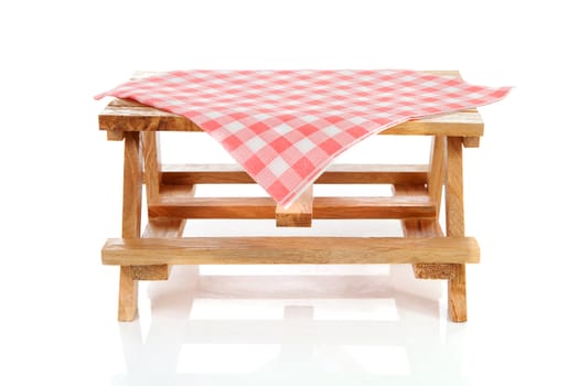 empty picnic table with tablecloth over white background
