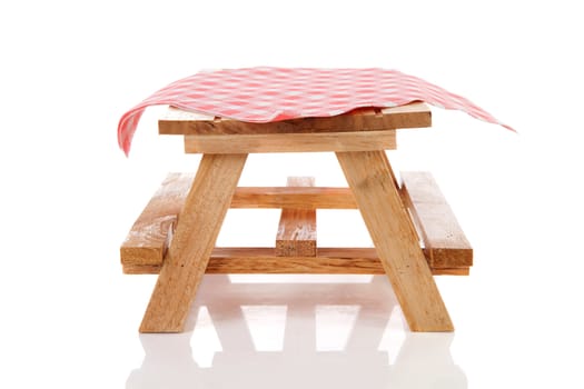 empty picnic table with tablecloth over white background