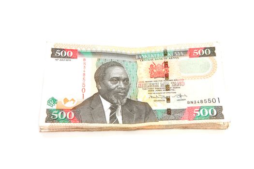 Pile of Kenyan currency over white background