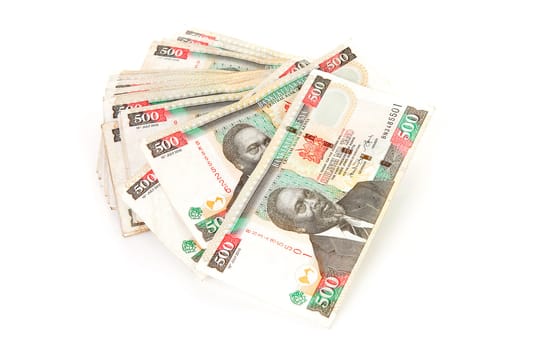 Pile of Kenyan currency over white background