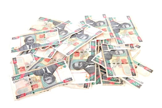Pile of Kenyan currency over white background