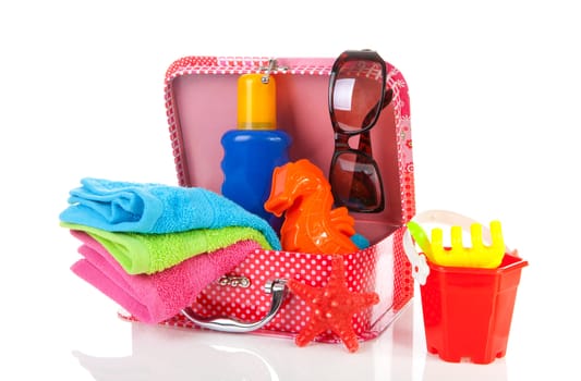 Going to the beach; accessories and suitcase over white background