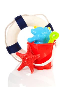 Beach toys and life buoy over white background