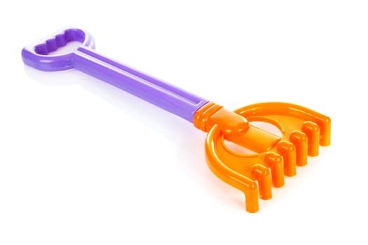 Colorful plastic rake over white background