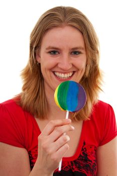 Young woman with colorful lolly over white background