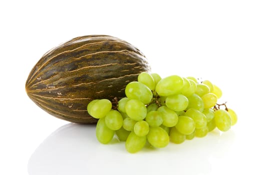 Fresh melon and grapes over white background
