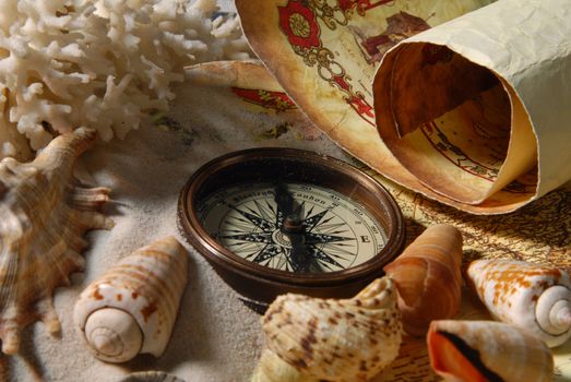 Compass and map on the background of the beach