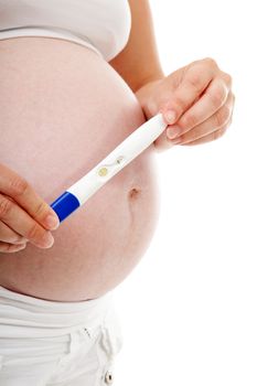 Woman is holding pregnancy test over belly isolated on white background