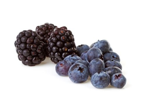 Macro of blackberries and currant berries over white background
