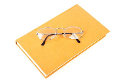 book with reading glasses isolated on white background