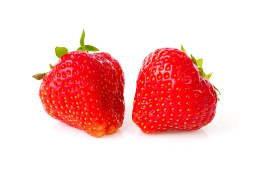 Two strawberries in closeup over white background