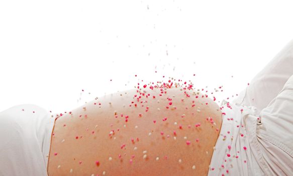 Pregnant belly with pink falling mice over white background