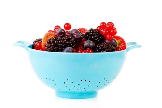 Blue colander with healthy fresh fruit over white background