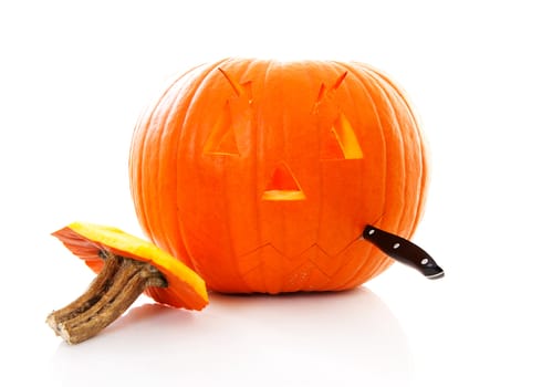 Making scary face out of pumpkin over white background
