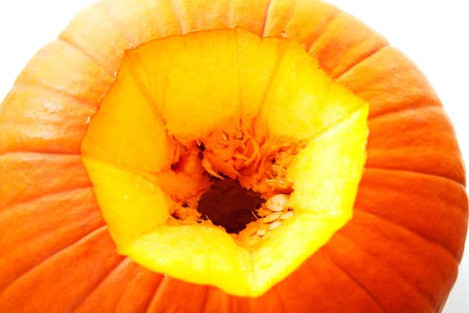 Closeup of hole in pumpkin over white