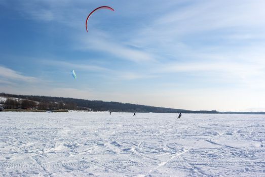 Winter kite skiing on the frozen river