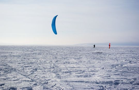Winter kite skiing on the frozen river