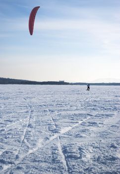 Winter kite skiing on the frozen river