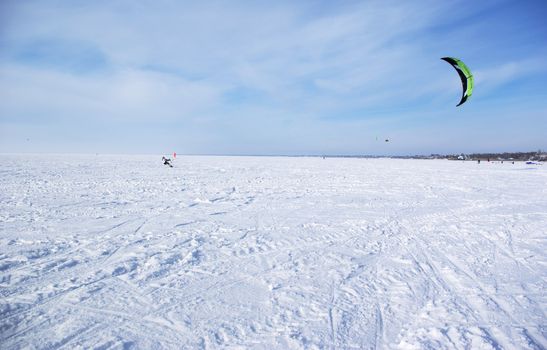 Winter kite skiing on the frozen river