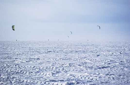 Winter kite skiing on the frozen river