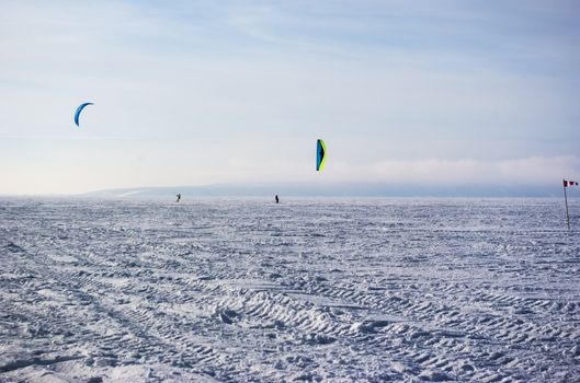 Winter kite skiing on the frozen river