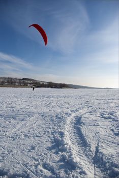 Winter kite skiing on the frozen river