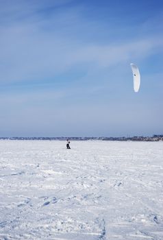 Winter kite skiing on the frozen river
