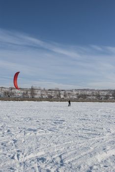 Winter kite skiing on the frozen river