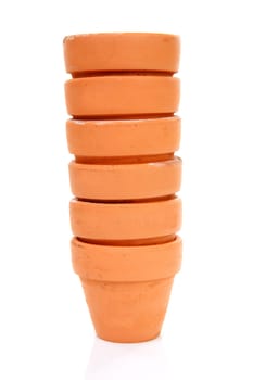 pile of terracotta garden pots over white background