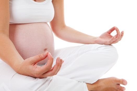 closeup of woman doing meditative pregnancy yoga over white background