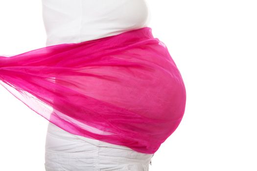 closeup of pregnant belly with pink cloth over white background