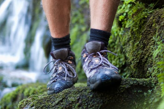 Hiking boots in outdoor action with a waterfall backgroung