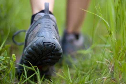 Closeup of a hiking boots in a grass